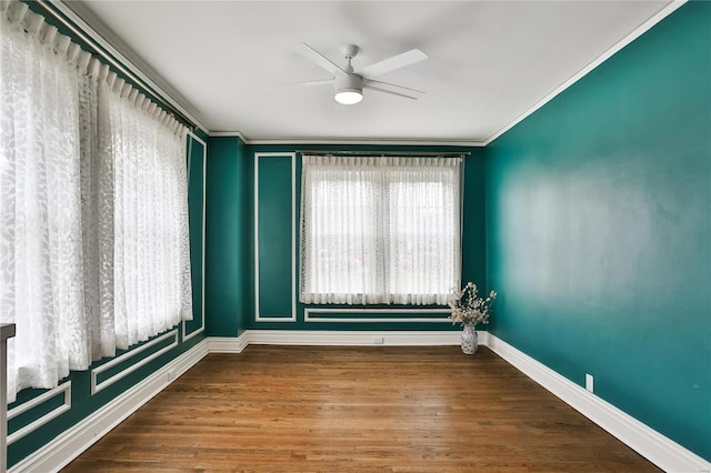 unfurnished room with ornamental molding, ceiling fan, baseboards, and wood finished floors