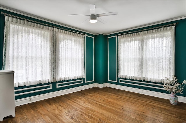 unfurnished room featuring baseboards, a ceiling fan, healthy amount of natural light, and wood finished floors