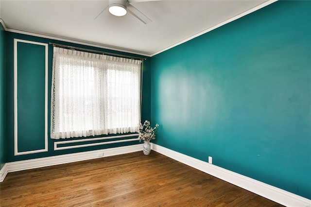 empty room with baseboards, a ceiling fan, ornamental molding, and wood finished floors