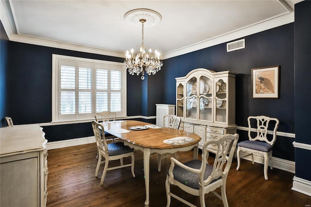 dining space with a chandelier, dark wood finished floors, crown molding, and baseboards