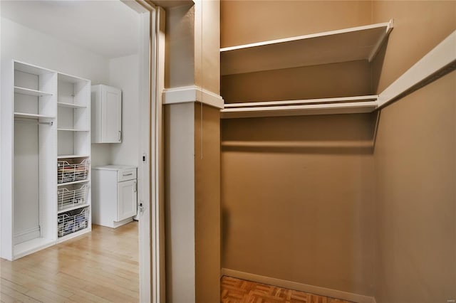 walk in closet with light wood-type flooring
