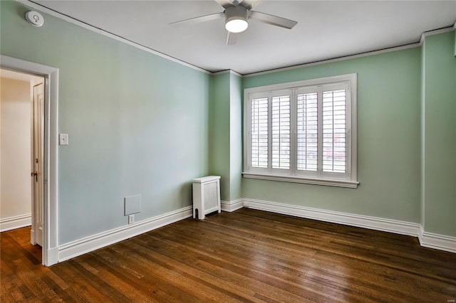empty room featuring ceiling fan, ornamental molding, baseboards, and wood finished floors