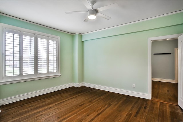 unfurnished room with baseboards, ceiling fan, and wood finished floors