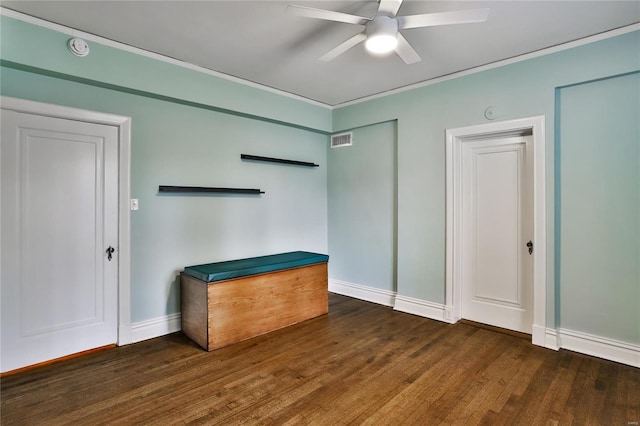 unfurnished bedroom with wood finished floors, baseboards, crown molding, and a ceiling fan