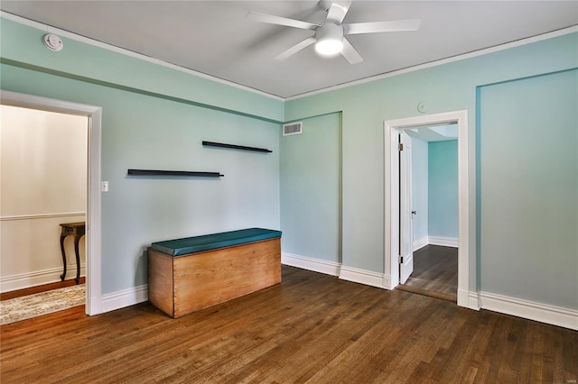 unfurnished living room featuring a ceiling fan, wood finished floors, baseboards, and crown molding