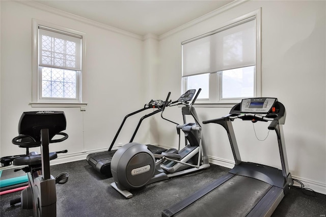 exercise area with crown molding and baseboards