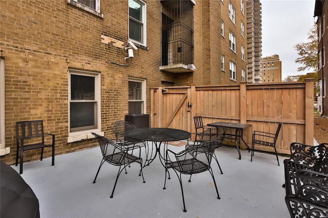 view of patio featuring outdoor dining space and fence