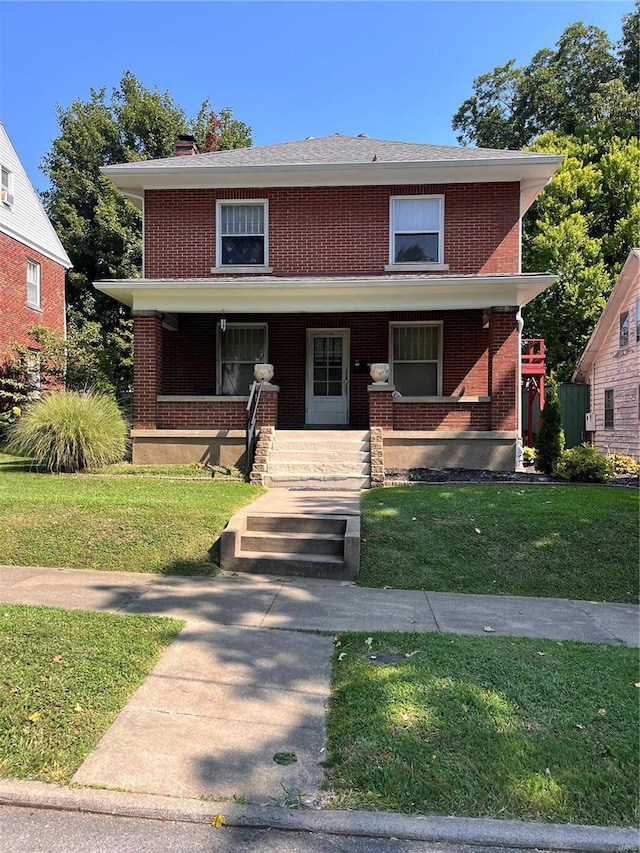 1442 Themis St, Cape Girardeau, MO 63701 - traditional style home featuring brick siding, a front lawn, covered porch, and a chimney
