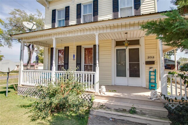 202 4th St, Carrollton, IL 62016 - doorway to property featuring covered porch