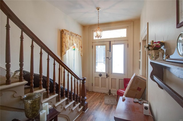 202 4th St, Carrollton, IL 62016 - foyer entrance featuring stairway, wood finished floors, and a chandelier