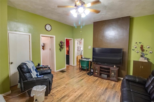 202 4th St, Carrollton, IL 62016 - living area with a ceiling fan, wood finished floors, and baseboards