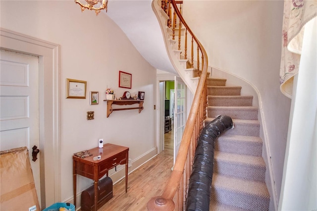 202 4th St, Carrollton, IL 62016 - stairway featuring wood finished floors, lofted ceiling, and baseboards