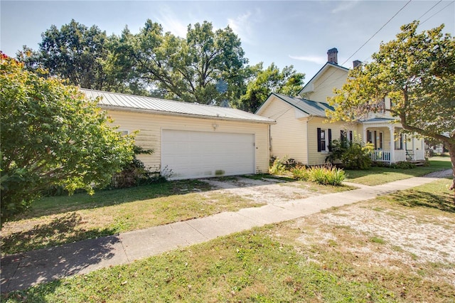 202 4th St, Carrollton, IL 62016 - view of front of property featuring a front yard, a porch, and metal roof