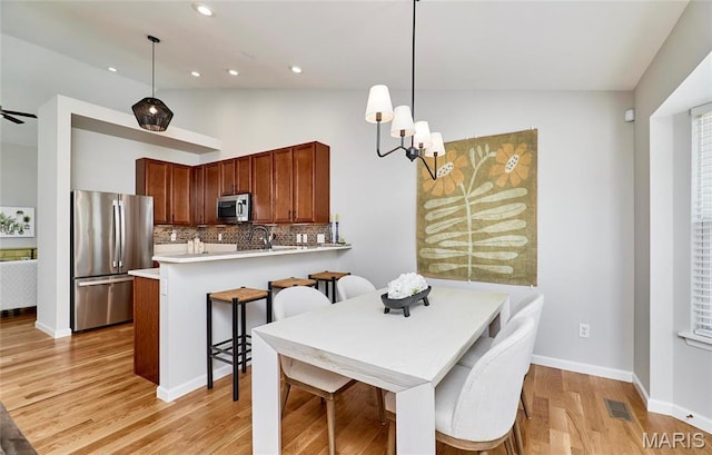 1538 Cattail Way, Saint Charles, MO 63303 - dining space featuring light wood finished floors, lofted ceiling, a chandelier, recessed lighting, and baseboards