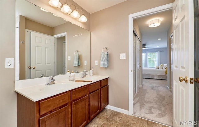 1538 Cattail Way, Saint Charles, MO 63303 - ensuite bathroom with a ceiling fan, double vanity, baseboards, and tile patterned flooring