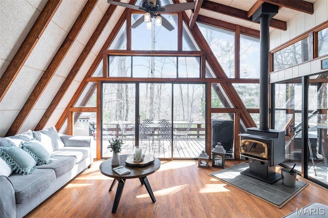 682 Shadow Lake Circle Dr, Innsbrook, MO 63390 - living area with a wood stove, high vaulted ceiling, a wall of windows, beam ceiling, and ceiling fan