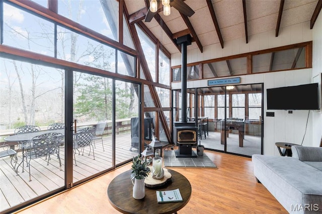 682 Shadow Lake Circle Dr, Innsbrook, MO 63390 - living room featuring high vaulted ceiling, a wood stove, ceiling fan, wood finished floors, and beamed ceiling