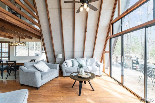 682 Shadow Lake Circle Dr, Innsbrook, MO 63390 - living room featuring a towering ceiling, light wood finished floors, a ceiling fan, and a chandelier