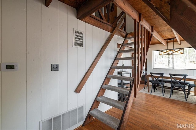 682 Shadow Lake Circle Dr, Innsbrook, MO 63390 - staircase with beamed ceiling, wood finished floors, and a chandelier