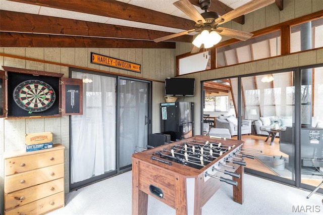 682 Shadow Lake Circle Dr, Innsbrook, MO 63390 - recreation room featuring beam ceiling, wood walls, carpet, a ceiling fan, and plenty of natural light