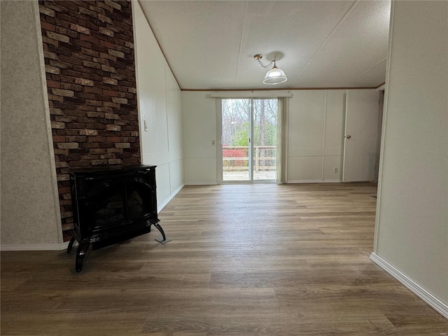 65 Bright St, Troy, MO 63379 - unfurnished living room featuring wood finished floors, baseboards, and lofted ceiling