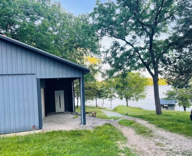 1 Golden Eagle Ferry Rd, Golden Eagle, IL 62036 - exterior space featuring board and batten siding, a lawn, and an outdoor structure