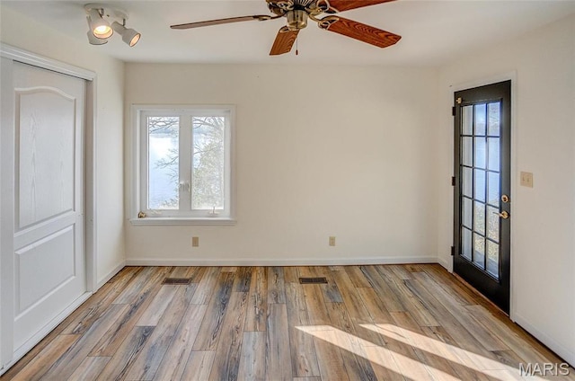1 Golden Eagle Ferry Rd, Golden Eagle, IL 62036 - empty room featuring plenty of natural light, wood finished floors, a ceiling fan, and baseboards