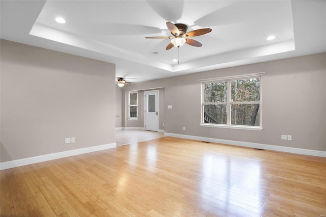 443 Mark Twain Loop, Union, MO 63084 - unfurnished room with a raised ceiling, a ceiling fan, recessed lighting, light wood-style flooring, and baseboards