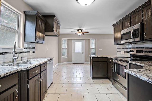 443 Mark Twain Loop, Union, MO 63084 - kitchen featuring stainless steel appliances, a sink, decorative backsplash, a ceiling fan, and dark brown cabinetry