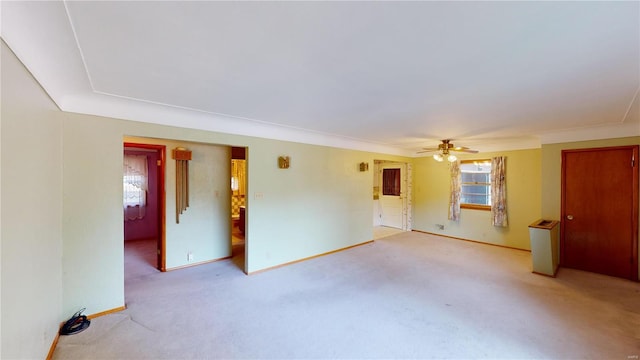spare room with light carpet, a ceiling fan, and baseboards