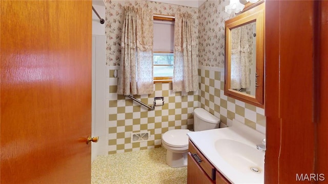 4645 S State Route 159, Glen Carbon, IL 62034 - bathroom with vanity, a wainscoted wall, toilet, tile walls, and wallpapered walls