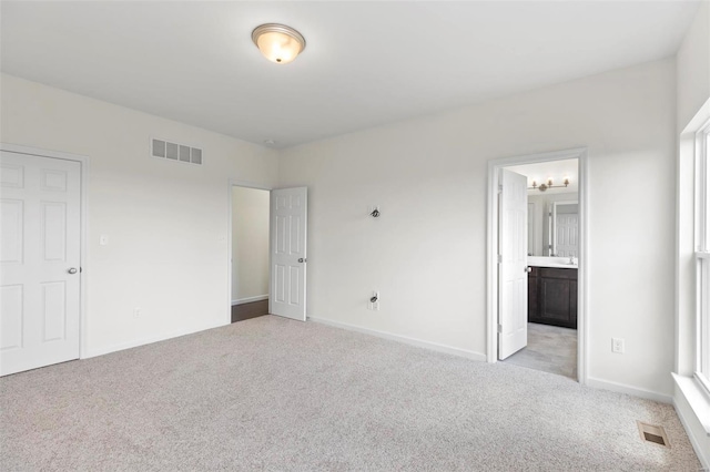 2491 Chukka Dr, Eureka, MO 63025 - unfurnished bedroom featuring light carpet, baseboards, ensuite bathroom, and a chandelier
