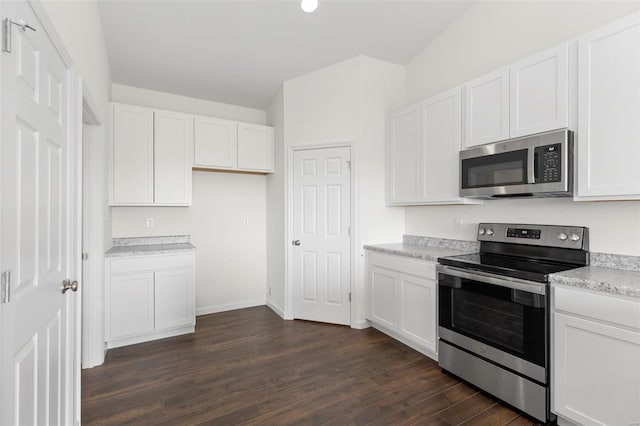 2491 Chukka Dr, Eureka, MO 63025 - kitchen with appliances with stainless steel finishes, dark wood finished floors, white cabinets, light countertops, and baseboards