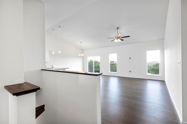 2491 Chukka Dr, Eureka, MO 63025 - kitchen featuring plenty of natural light, dark wood-style floors, lofted ceiling, ceiling fan, and a peninsula