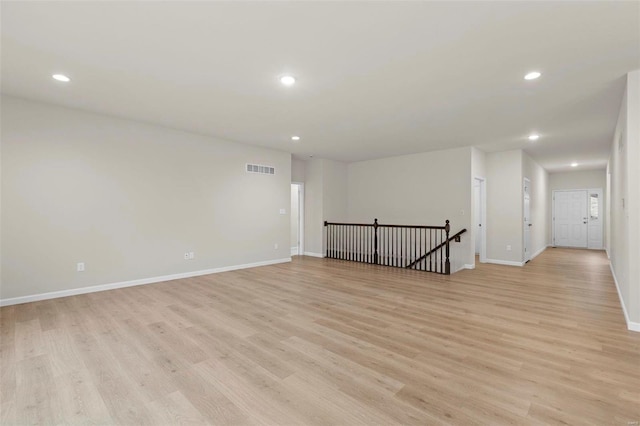 unfurnished room with recessed lighting, light wood-type flooring, and baseboards