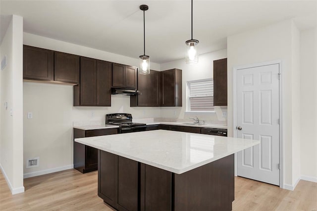 kitchen featuring black range oven, under cabinet range hood, dark brown cabinetry, and a sink