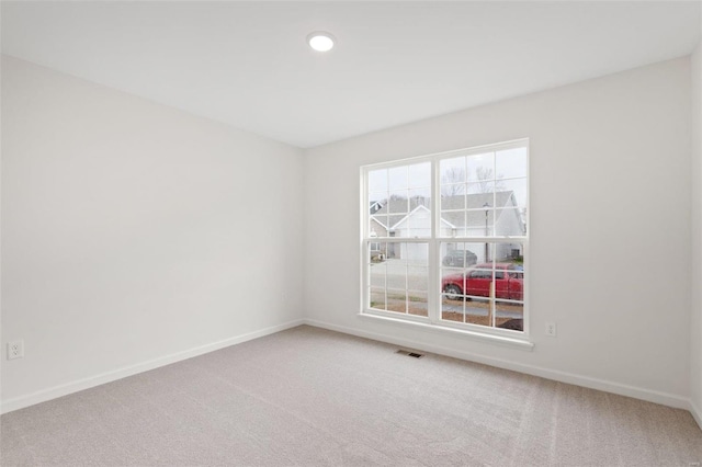 empty room featuring carpet floors, baseboards, and recessed lighting