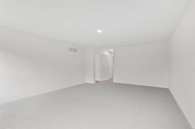 carpeted spare room featuring recessed lighting and baseboards