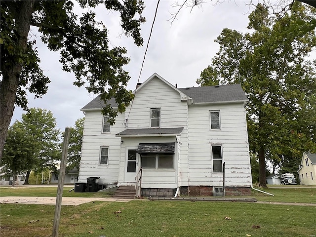 328 W Orrick, La Plata, MO 63549 - rear view of house with entry steps, a yard, roof with shingles, and central AC