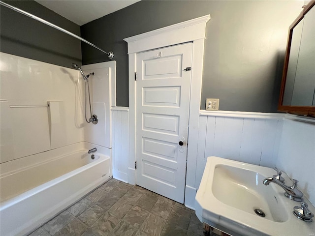 328 W Orrick, La Plata, MO 63549 - bathroom with a sink, a wainscoted wall, and  shower combination