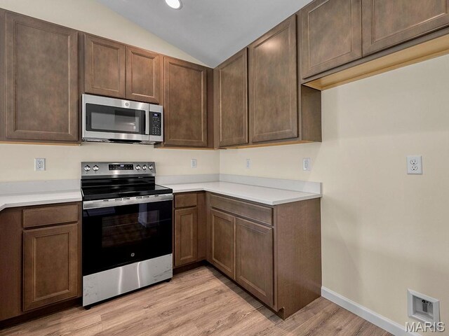 3136 White Pine Dr, Imperial, MO 63052 - kitchen with appliances with stainless steel finishes, lofted ceiling, light wood-style flooring, light countertops, and recessed lighting