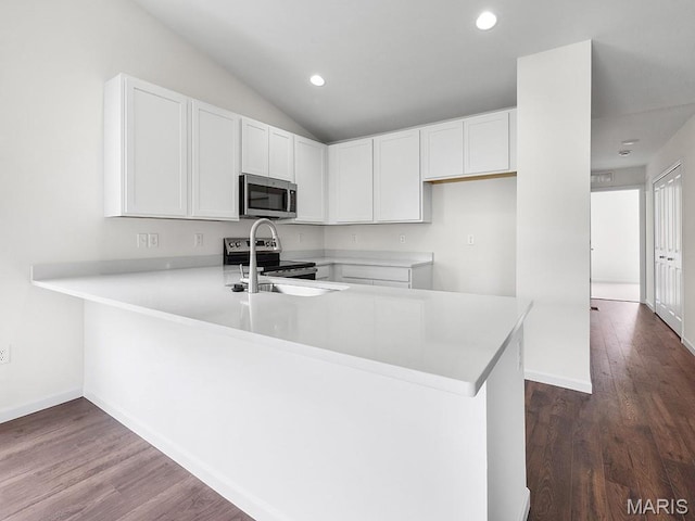 3128 White Pine Dr, Imperial, MO 63052 - kitchen with stainless steel appliances, a peninsula, light countertops, white cabinets, and recessed lighting