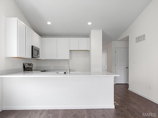 3128 White Pine Dr, Imperial, MO 63052 - kitchen featuring stainless steel appliances, lofted ceiling, a peninsula, light countertops, and white cabinetry