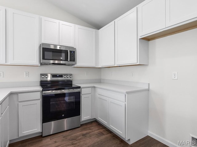 3128 White Pine Dr, Imperial, MO 63052 - kitchen featuring stainless steel appliances, vaulted ceiling, dark wood-style floors, and white cabinetry