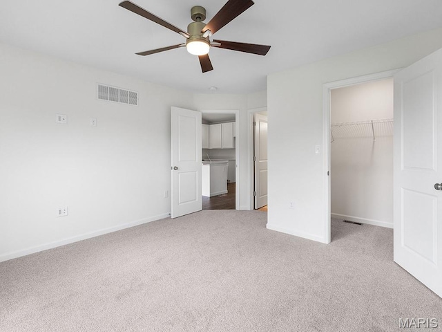 3128 White Pine Dr, Imperial, MO 63052 - unfurnished bedroom featuring carpet, a walk in closet, a closet, and a ceiling fan