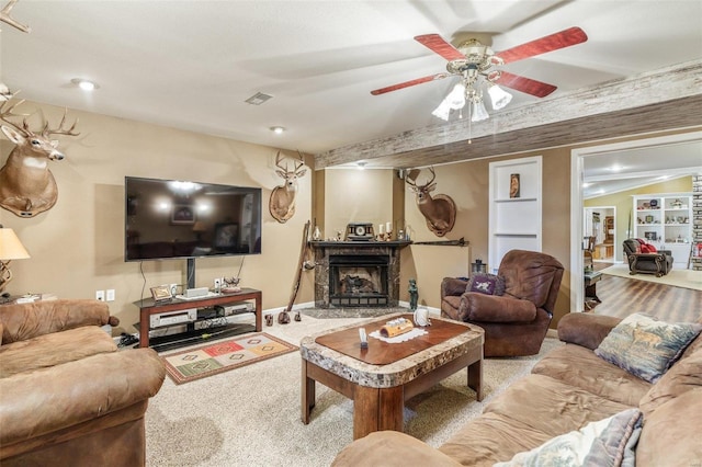 8041 Greystone Ln, Bonne Terre, MO 63628 - living area featuring carpet floors, a ceiling fan, and a fireplace with raised hearth