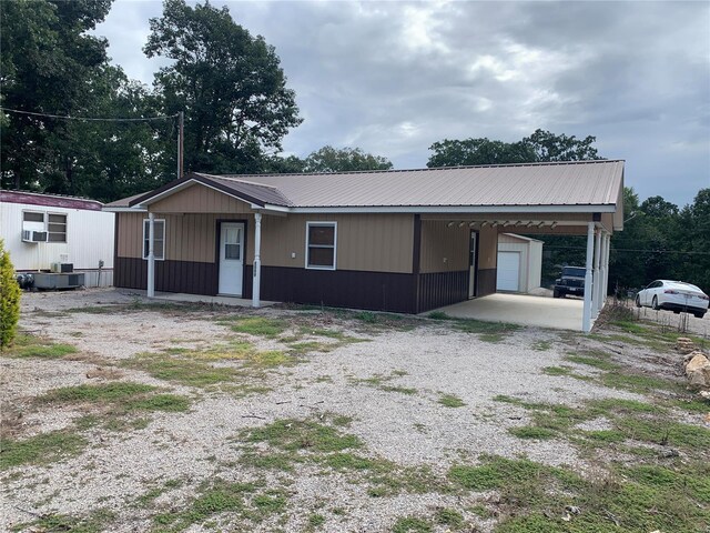 1099 Beverly Dr, Wappapello, MO 63966 - view of front of home with metal roof, a carport, and driveway