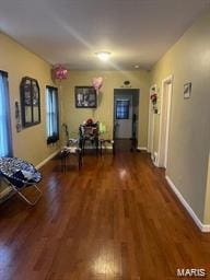 hall with wood finished floors and baseboards