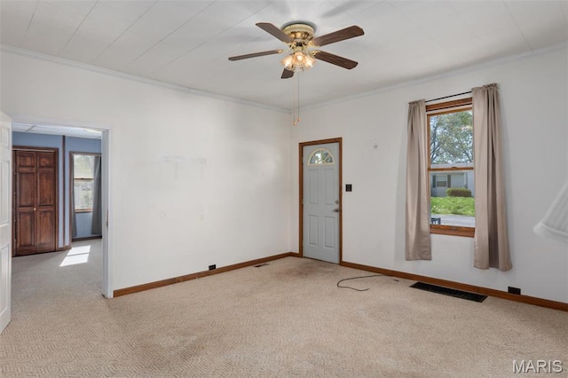 823 E Pearl St, Staunton, IL 62088 - unfurnished room with light colored carpet, ornamental molding, ceiling fan, and baseboards