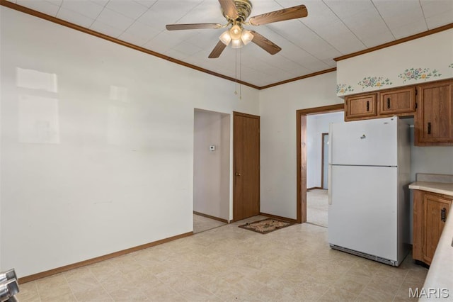 823 E Pearl St, Staunton, IL 62088 - kitchen with freestanding refrigerator, brown cabinetry, ornamental molding, ceiling fan, and light countertops